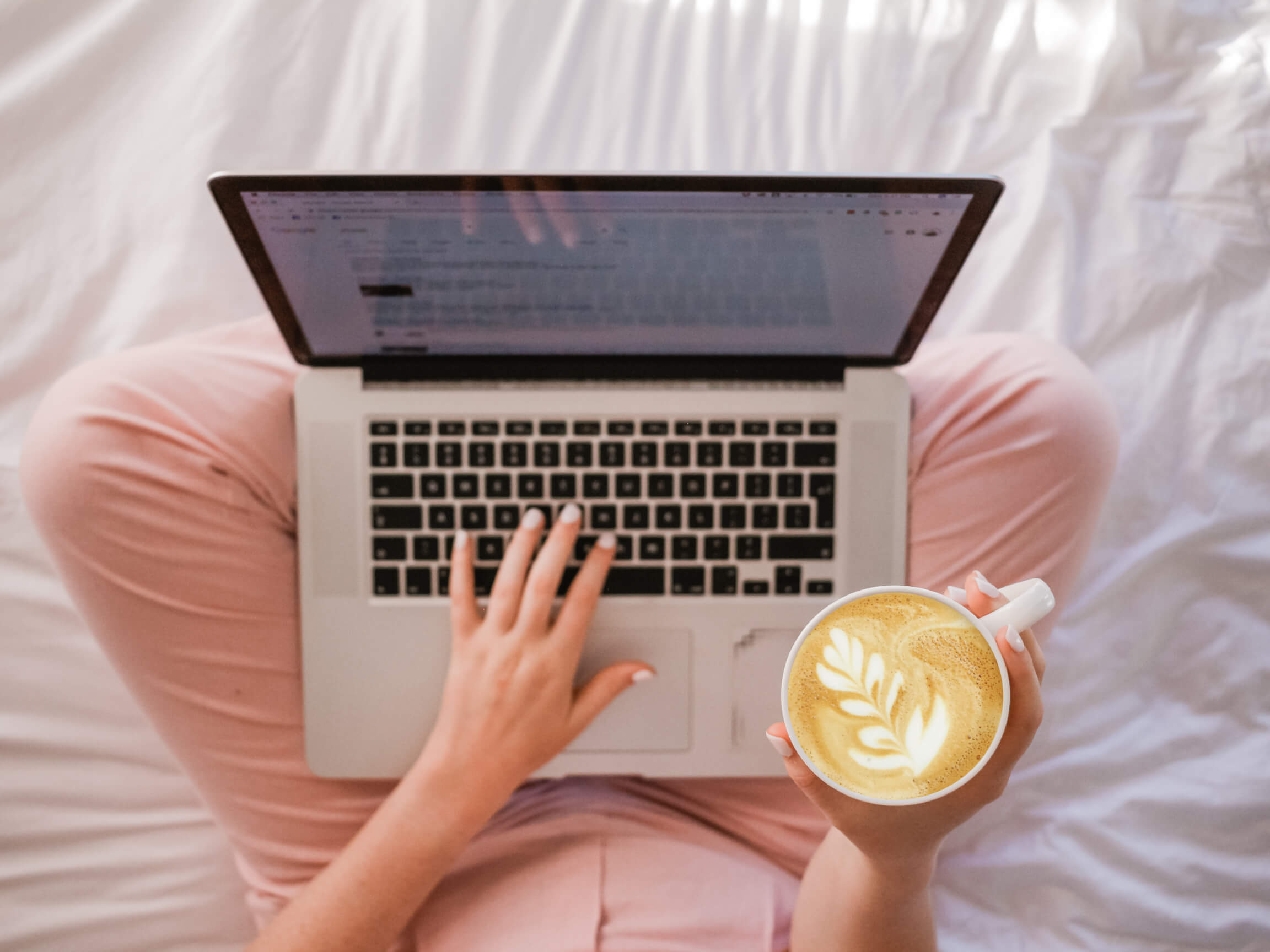 blogging and typing while holding coffee